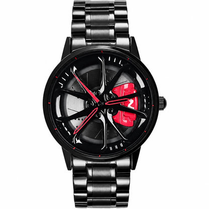 Reloj RNF de caja y brazalete negros, esfera de llanta negra con pinza y agujas rojas. Fotografía frontal.